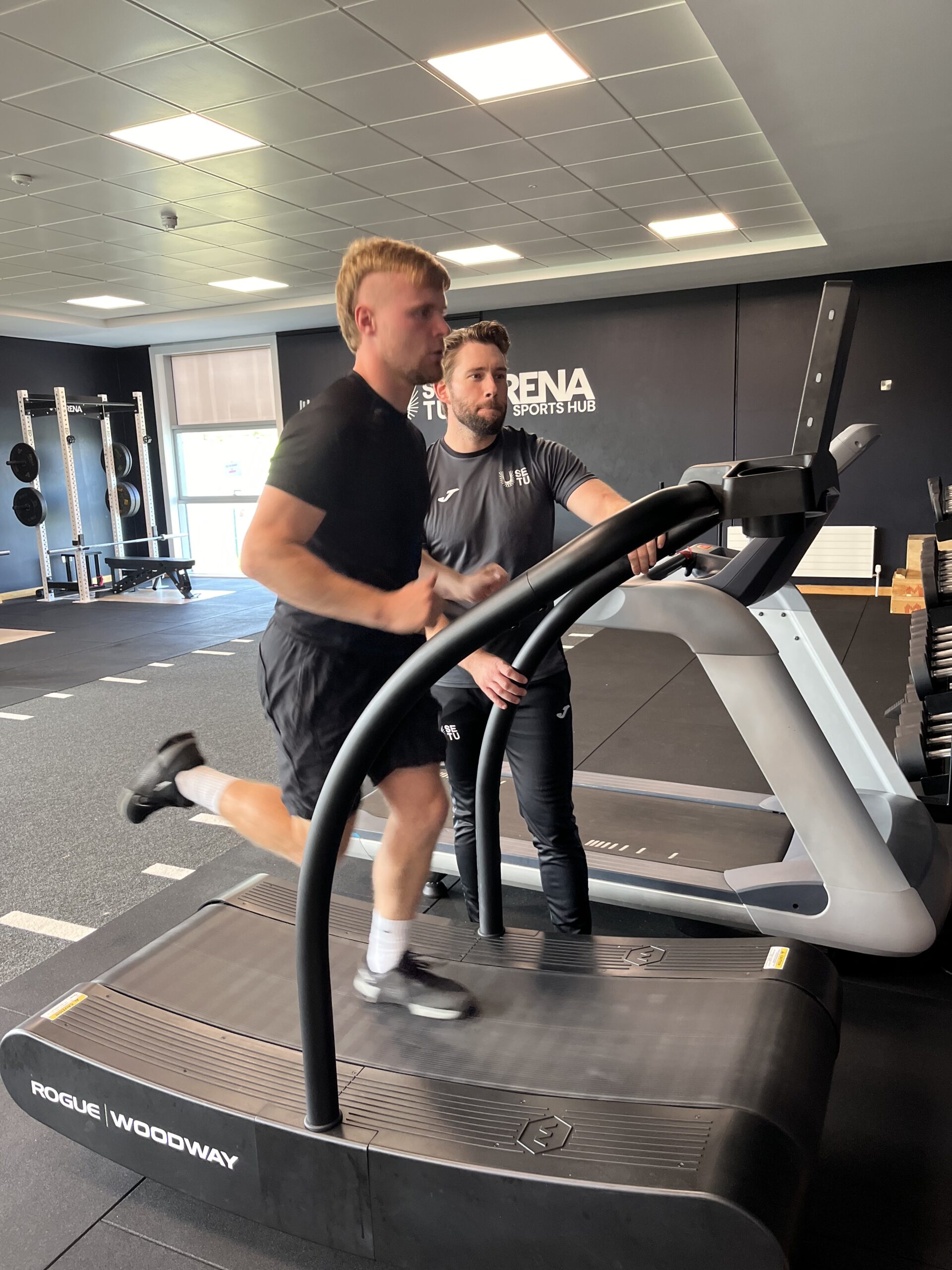 Man running on curved treadmill